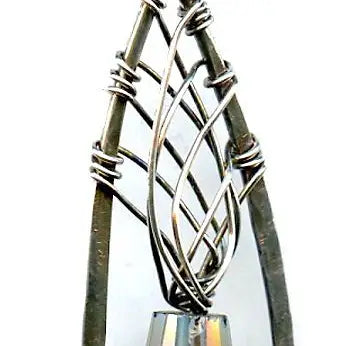 blue green crystal cone inside a brass chapel shaped earring woven with sterling silver fine wire