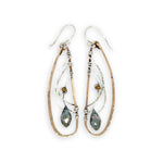 Handmade hammered bronze wings are embellished with sterling silver weaving holding a blue green crystal drop 