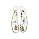 Handmade hammered bronze wings are embellished with sterling silver weaving holding a blue green crystal drop 