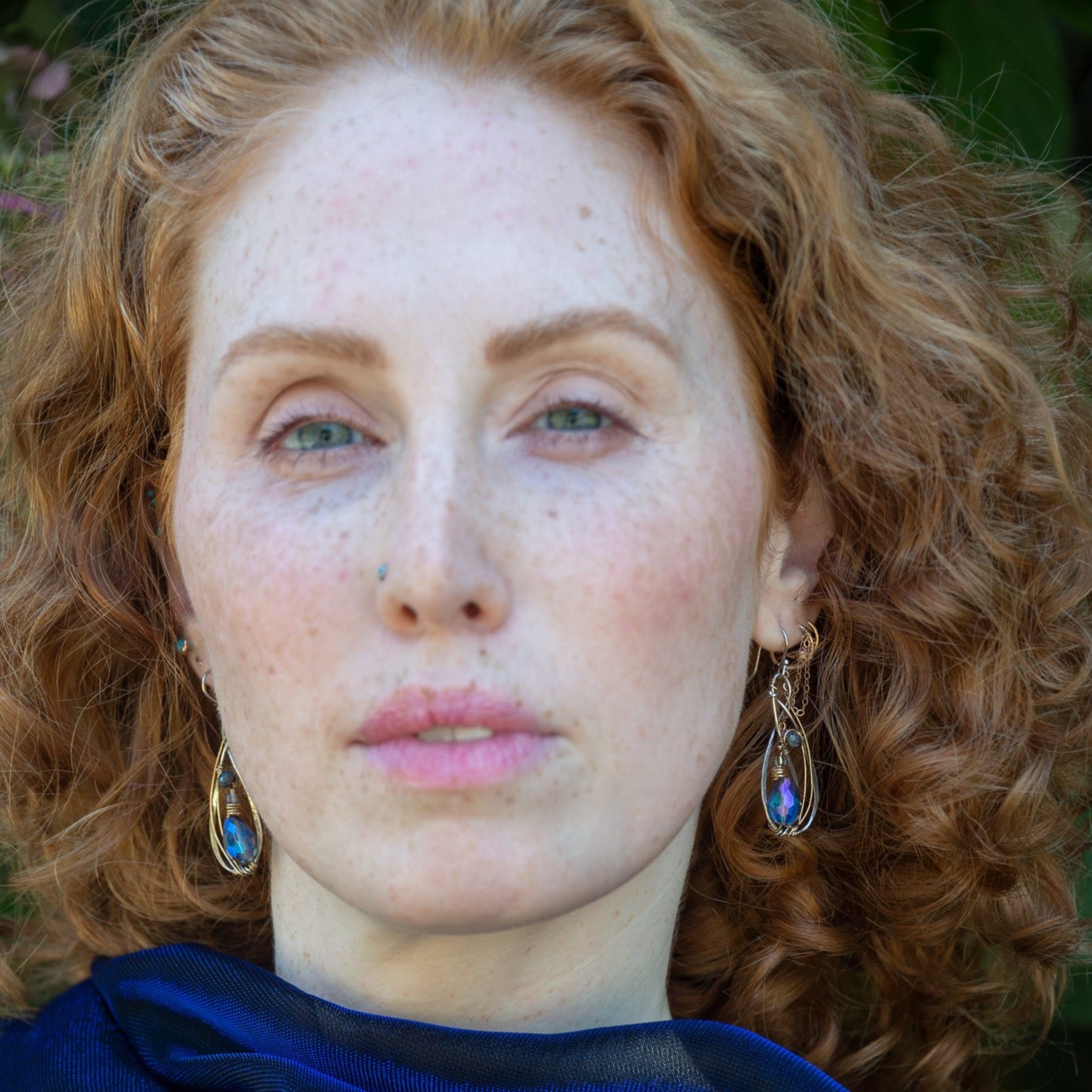 Blue crystal with lapis gemstone on a sterling silver infinity shape earrings accented with gold filled wire