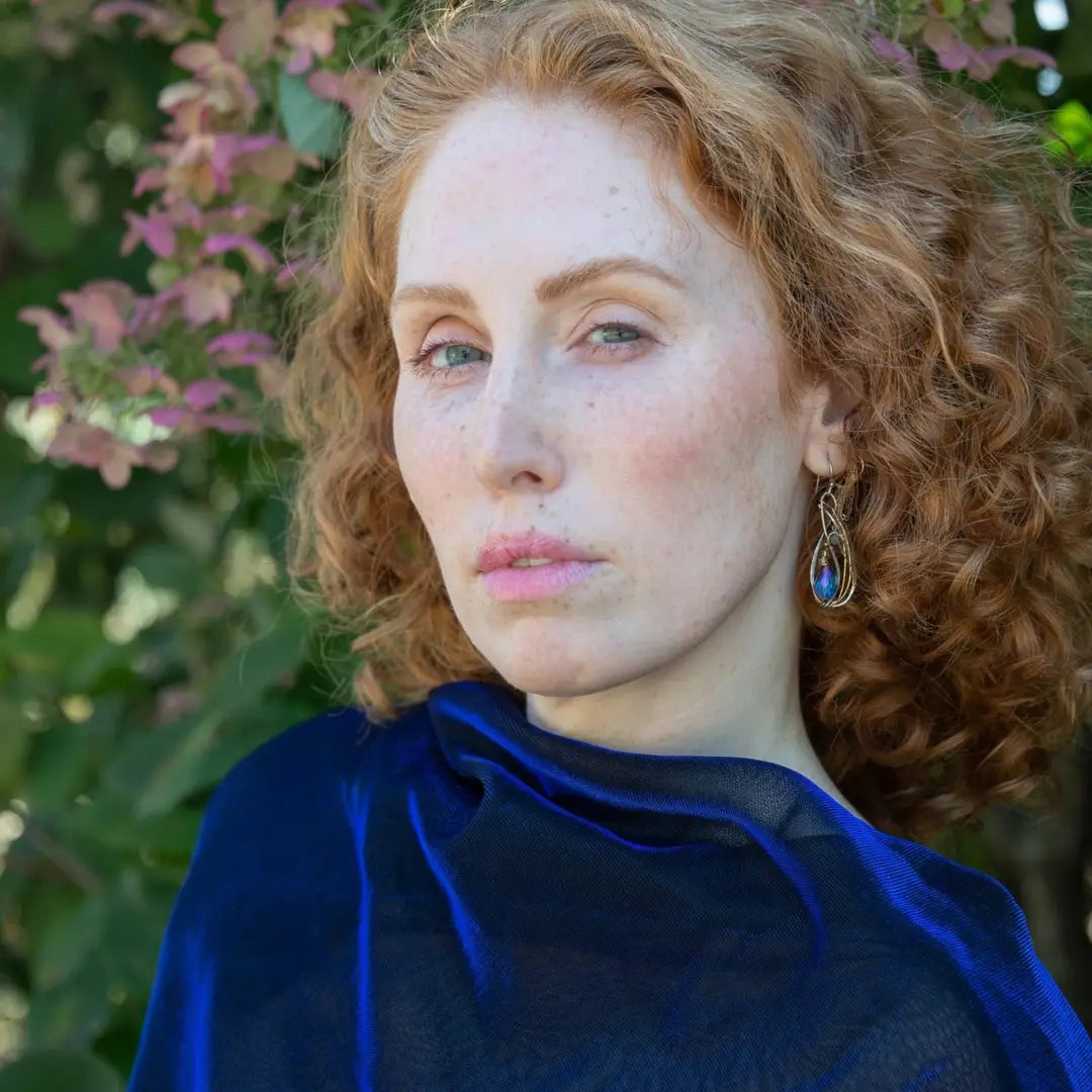 Blue crystal with lapis gemstone on a sterling silver infinity shape earrings accented with gold filled wire