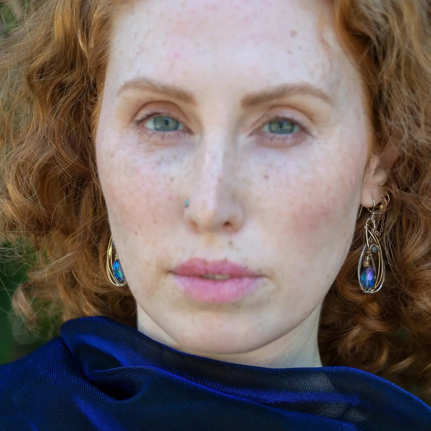 Blue crystal with lapis gemstone on a sterling silver infinity shape earrings accented with gold filled wire