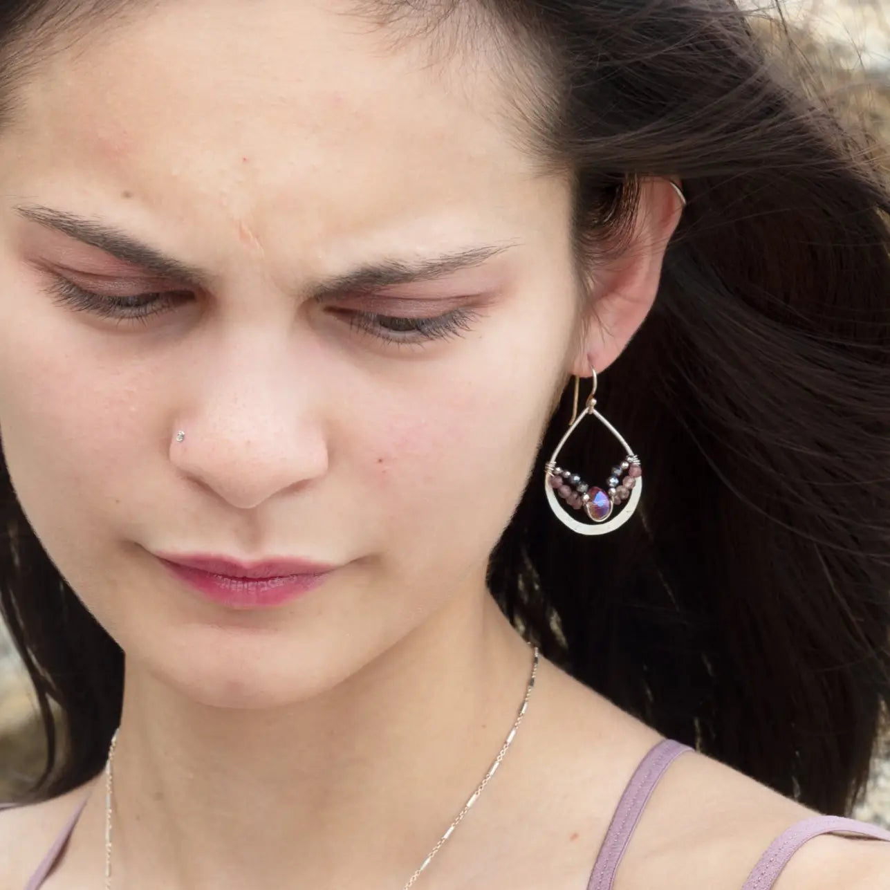 A pair of sterling silver hammered drop earrings with micro faceted pink tourmaline and pyrite gemstones, featuring a pink crystal at the center