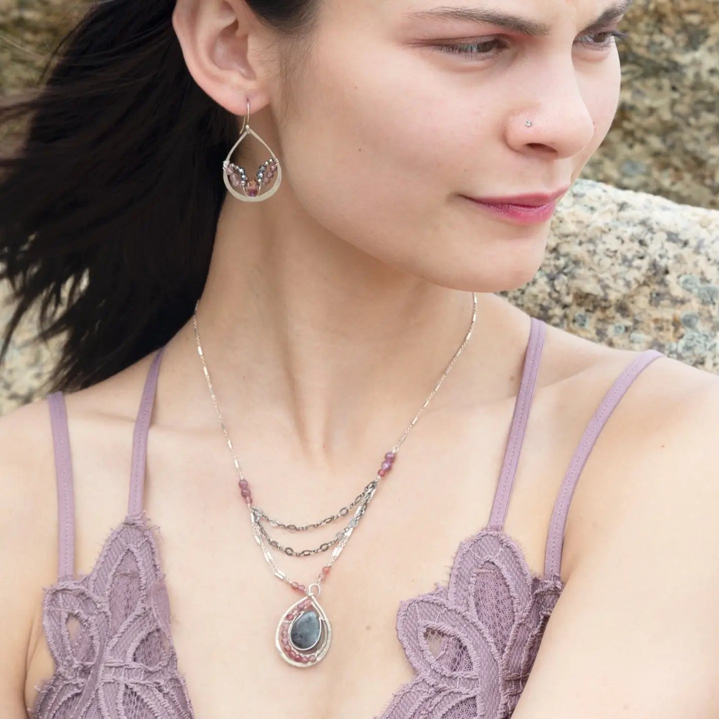A pair of sterling silver hammered drop earrings with micro faceted pink tourmaline and pyrite gemstones, featuring a pink crystal at the center