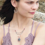 A pair of sterling silver hammered drop earrings with micro faceted pink tourmaline and pyrite gemstones, featuring a pink crystal at the center