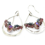 A pair of sterling silver hammered drop earrings with micro faceted pink tourmaline and pyrite gemstones, featuring a pink crystal at the center