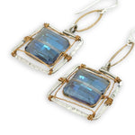 Faceted blue crystal tiles are wrapped tightly in brass twist wire inside a stamped sterling silver box earring, hanging from a gold filled link