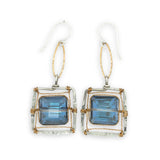 Faceted blue crystal tiles are wrapped tightly in brass twist wire inside a stamped sterling silver box earring, hanging from a gold filled link