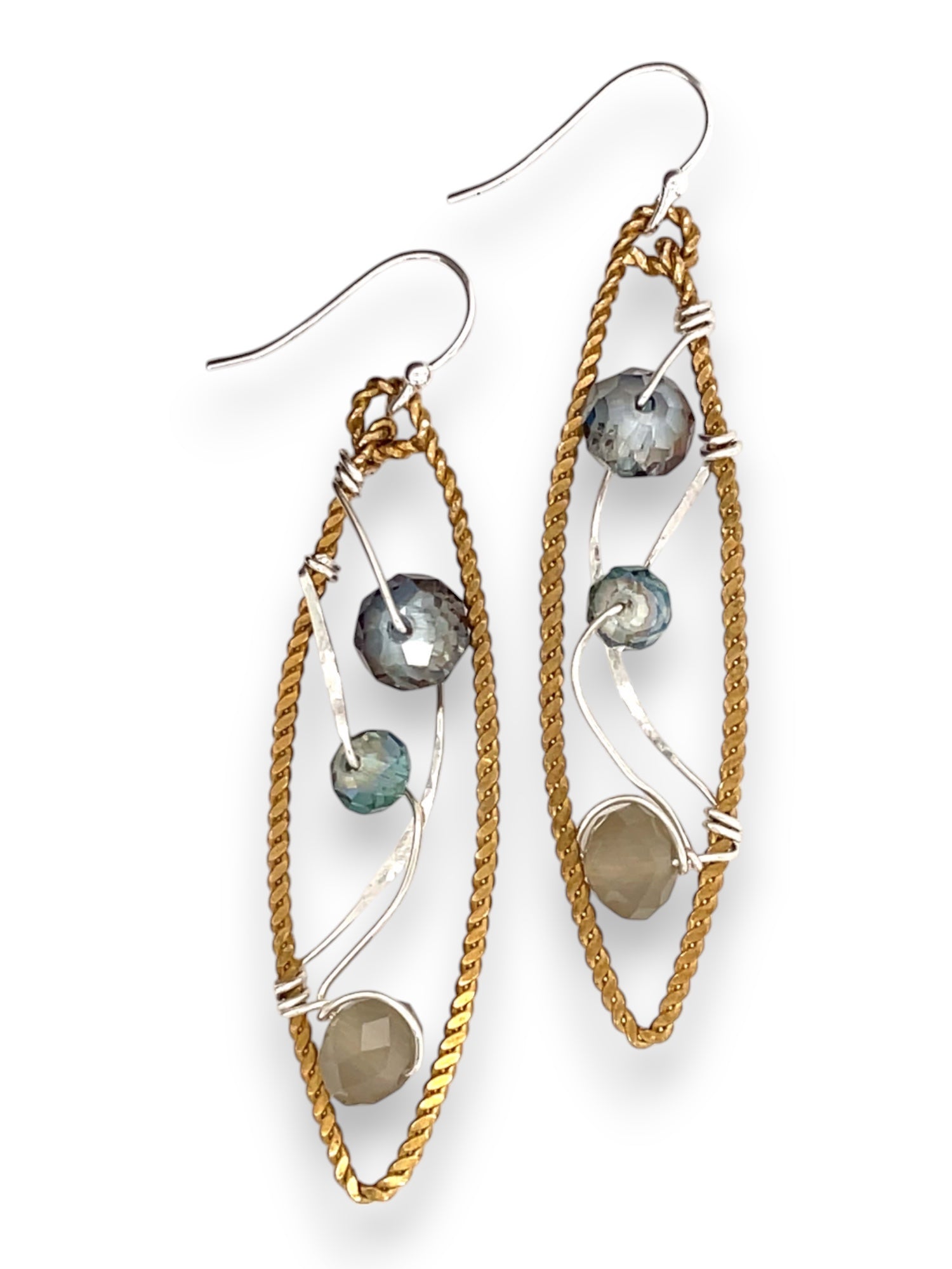 A pair of handmade brass twisted marquise earrings with hammered sterling silver and sparkling crystals in blue, green, and grey colors.