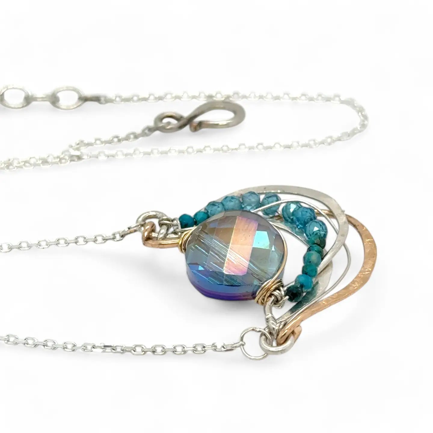waves of hammered bronze and sterling silver necklace hold a purple-blue crystal coin with chrysocolla and apatite gemstone accents