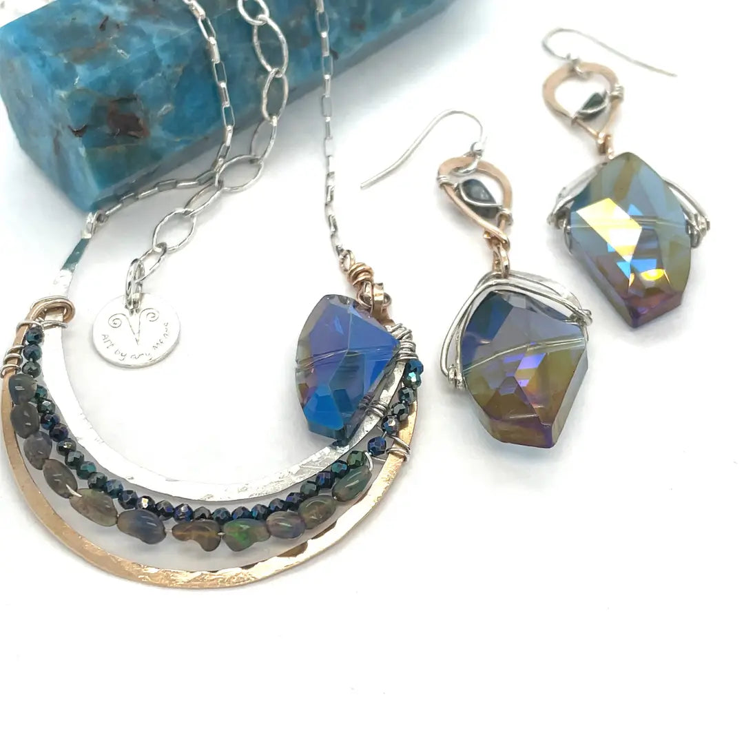 Bronze and sterling silver hammered pendant with blue/purple large crystal with black opal and crystal accents, on a sterling silver box chain necklace