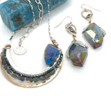 Bronze and sterling silver hammered pendant with blue/purple large crystal with black opal and crystal accents, on a sterling silver box chain necklace