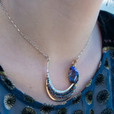Bronze and sterling silver hammered pendant with blue/purple large crystal with black opal and crystal accents, on a sterling silver box chain necklace