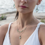 A mini sterling silver pendant with jade and green opal gemstones on gold filled wire hanging from a triple layer chain, with green onyx gemstones, sterling silver heart chain and gold fill accented chain necklace