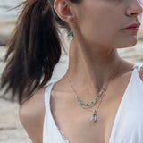 A mini sterling silver pendant with jade and green opal gemstones on gold filled wire hanging from a triple layer chain, with green onyx gemstones, sterling silver heart chain and gold fill accented chain necklace