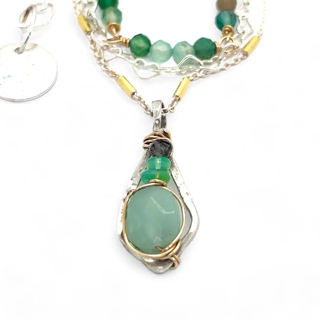 A mini sterling silver pendant with jade and green opal gemstones on gold filled wire hanging from a triple layer chain, with green onyx gemstones, sterling silver heart chain and gold fill accented chain necklace
