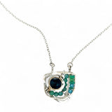 A sterling silver necklace with a faceted dark teal apatite coin set in gold fill centers, surrounded by cubic zirconia and green opal gemstones, with a mini sterling silver clasp.