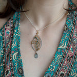 Sterling silver marquise necklace with moss agate and rutilated quartz gemstones in waves of brass and oxidized sterling twist wires