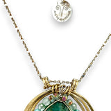 A brass triple circle necklace with turquoise and green fluorite faceted gemstones, featuring an adjustable gold-filled and sterling silver chain 
