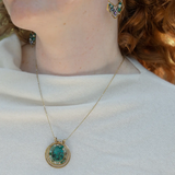 A brass triple circle necklace with turquoise and green fluorite faceted gemstones, featuring an adjustable gold-filled and sterling silver chain 