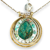 A brass triple circle necklace with turquoise and green fluorite faceted gemstones, featuring an adjustable gold-filled and sterling silver chain 