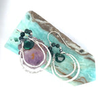 Double sterling silver hoop earrings hanging from bloodstone faceted gemstones with a dark green drop hanging in the center