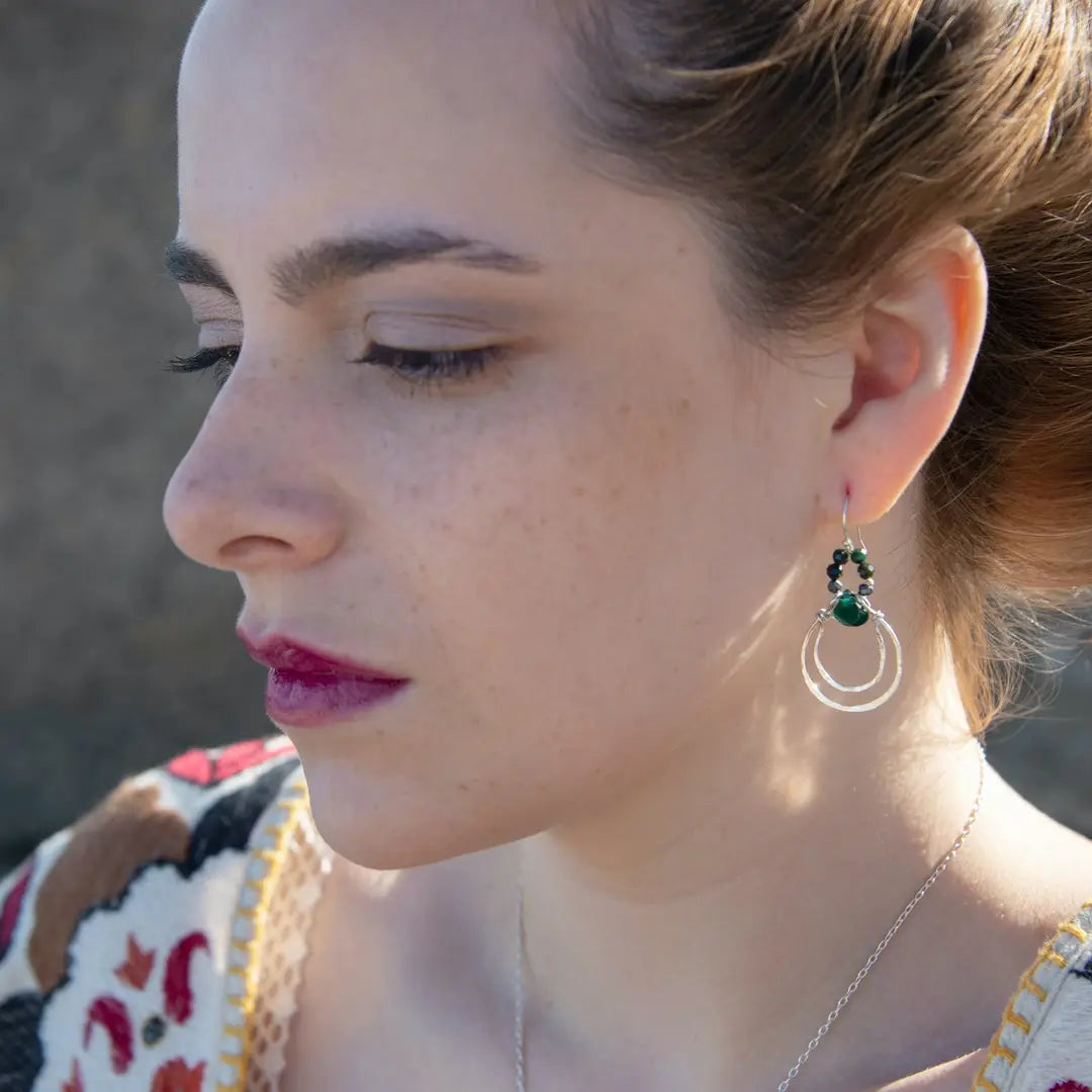 Double sterling silver hoop earrings hanging from bloodstone faceted gemstones with a dark green drop hanging in the center