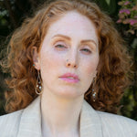 Variety of blue, purple, cream and rust fresh water pearls wrapped in hammered copper wire held onto a sterling silver drop earring