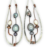 Variety of blue, purple, cream and rust fresh water pearls wrapped in hammered copper wire held onto a sterling silver drop earring