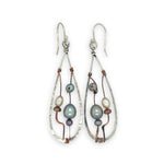 Variety of blue, purple, cream and rust fresh water pearls wrapped in hammered copper wire held onto a sterling silver drop earring