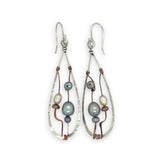 Variety of blue, purple, cream and rust fresh water pearls wrapped in hammered copper wire held onto a sterling silver drop earring