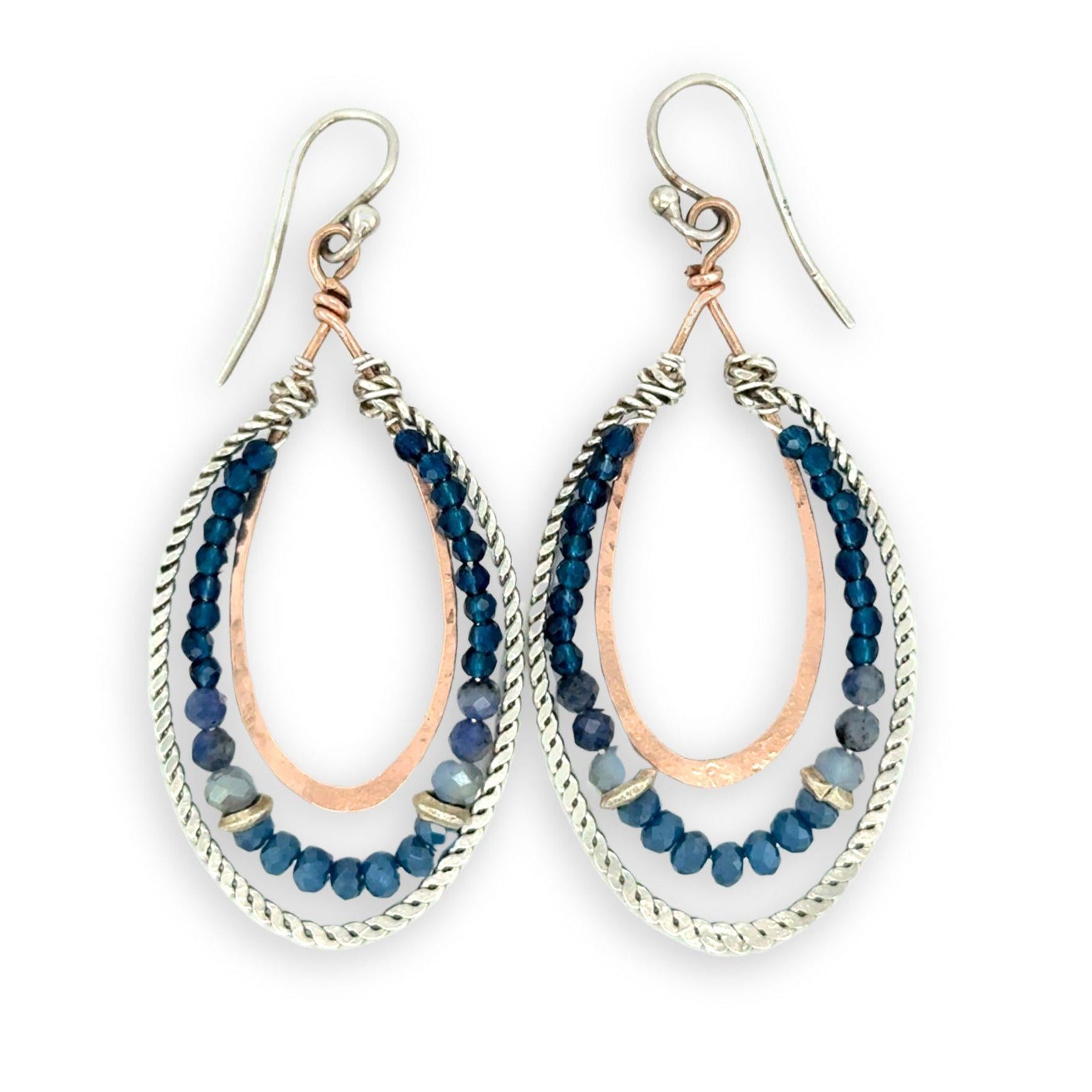 Blue crystal, sodalite, and rich blue quartz gemstones are set between bronze hammered drops and hammered oxidized sterling silver twist earrings