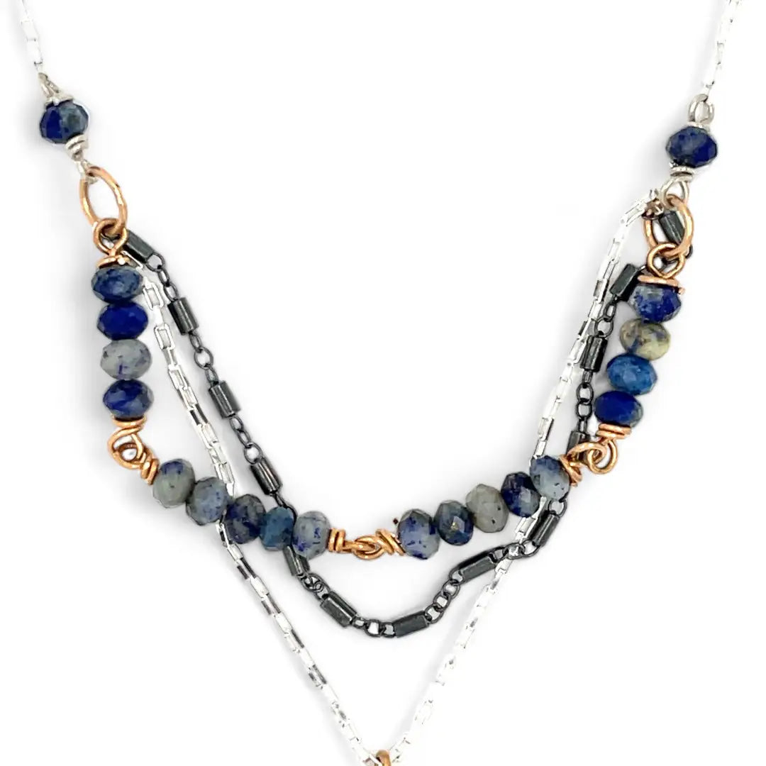 A sterling silver and bronze triple strand chain necklace with blue lapis and sodalite gemstones