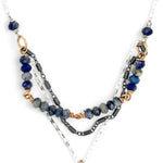 A sterling silver and bronze triple strand chain necklace with blue lapis and sodalite gemstones