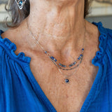 A sterling silver and bronze triple strand chain necklace with blue lapis and sodalite gemstones