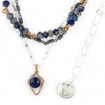 A sterling silver and bronze triple strand chain necklace with blue lapis and sodalite gemstones