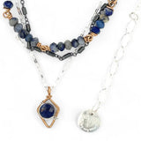A sterling silver and bronze triple strand chain necklace with blue lapis and sodalite gemstones