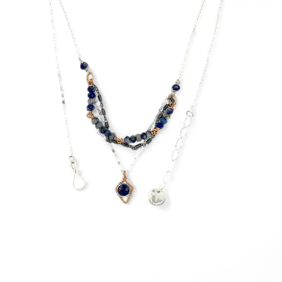 A sterling silver and bronze triple strand chain necklace with blue lapis and sodalite gemstones