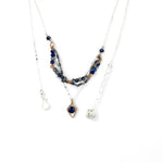 A sterling silver and bronze triple strand chain necklace with blue lapis and sodalite gemstones