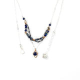 A sterling silver and bronze triple strand chain necklace with blue lapis and sodalite gemstones