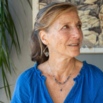 A sterling silver and bronze triple strand chain necklace with blue lapis and sodalite gemstones