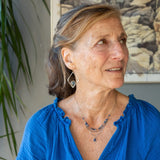 A sterling silver and bronze triple strand chain necklace with blue lapis and sodalite gemstones