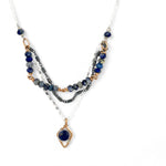 A sterling silver and bronze triple strand chain necklace with blue lapis and sodalite gemstones