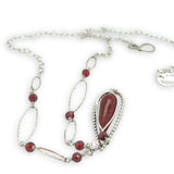 red fire agate drop gemstone held in sterling silver dot wire teardrop pendant necklace with cubic zirconia and sparkly sterling link accents