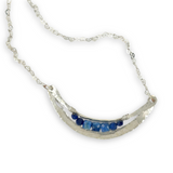 Silver necklace with a crescent moon-shaped pendant featuring blue kyanite cubes and lapis faceted gemstones on heart chain sterling silver chain necklace