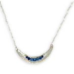 Silver necklace with a crescent moon-shaped pendant featuring blue kyanite cubes and lapis faceted gemstones on heart chain sterling silver chain necklace