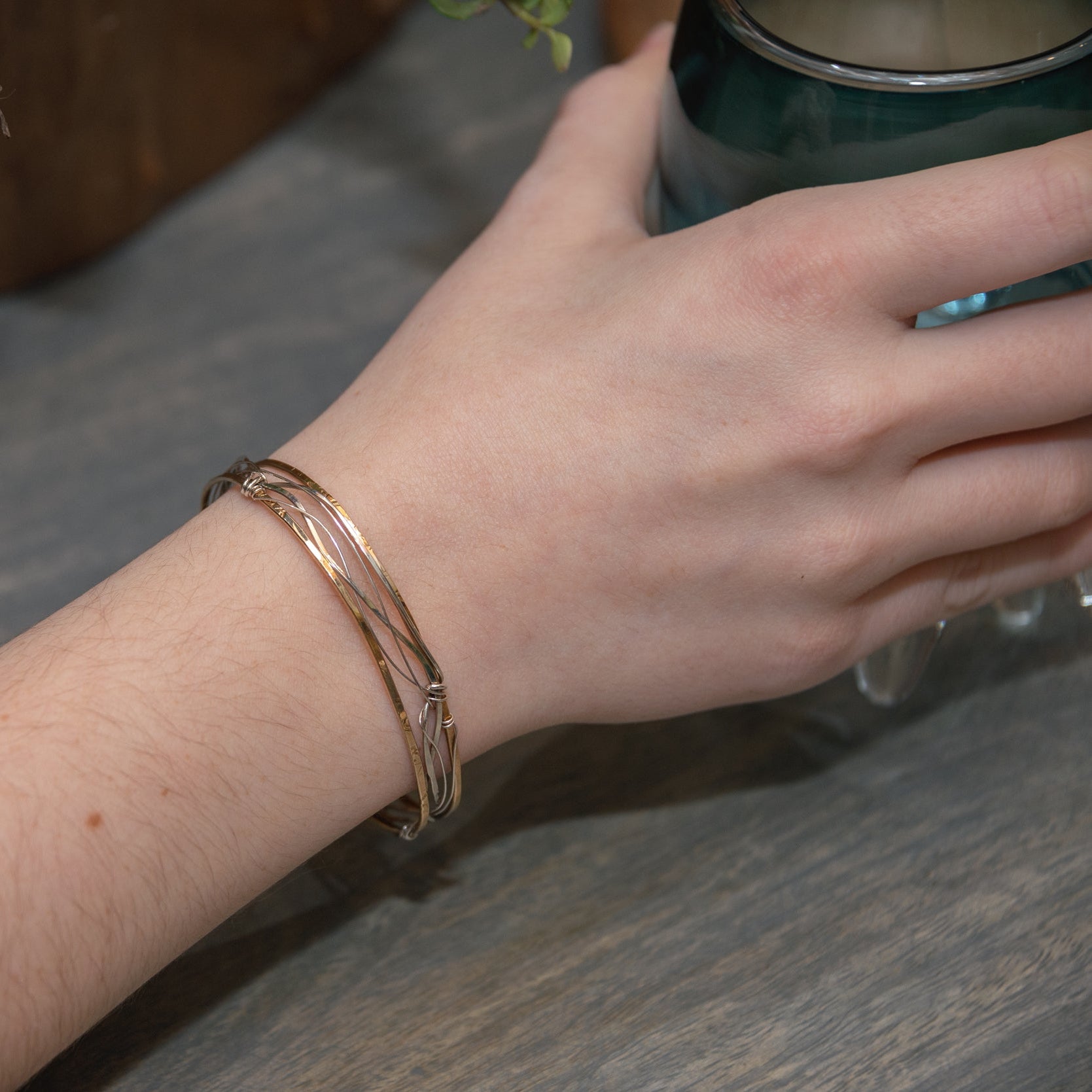 Handmade stamped brass skinny bracelet braided with oxidized sterling silver and gold filled wires