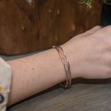 Handmade stamped brass skinny bracelet braided with oxidized sterling silver and gold filled wires