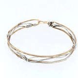 Handmade stamped brass skinny bracelet braided with oxidized sterling silver and gold filled wires