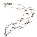 A mixed metal necklace with brass diamond hammered shapes and darkened sterling silver diamond cut links, with sterling silver box chain